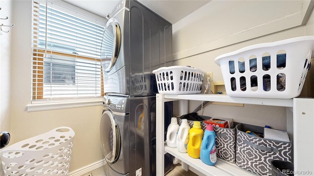 clothes washing area featuring stacked washer / drying machine