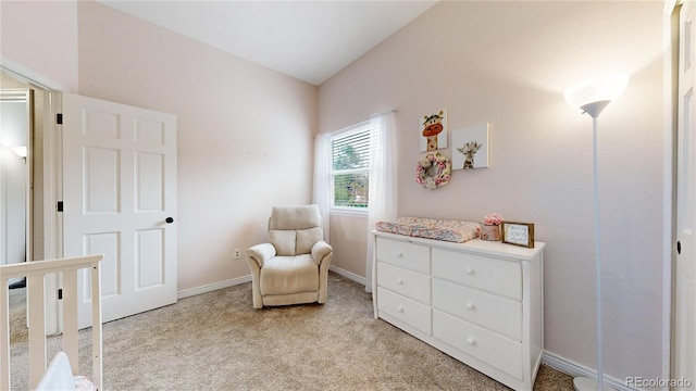 sitting room with light colored carpet and vaulted ceiling