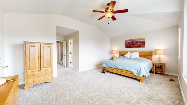 carpeted bedroom with ceiling fan and vaulted ceiling