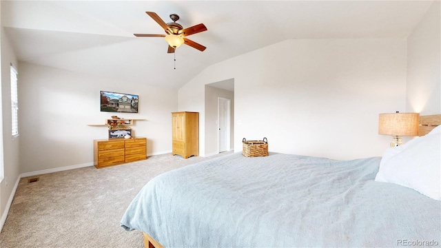 bedroom with ceiling fan, carpet floors, and vaulted ceiling