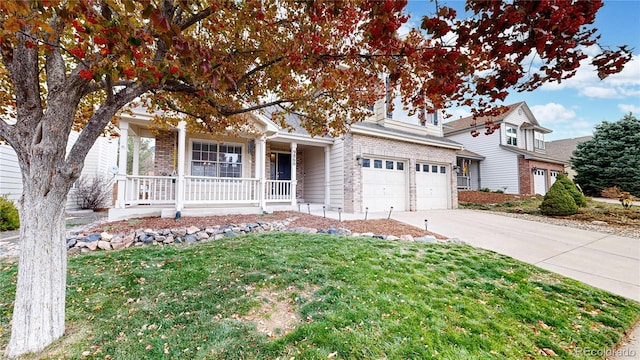 view of front of house featuring a front yard, a porch, and a garage