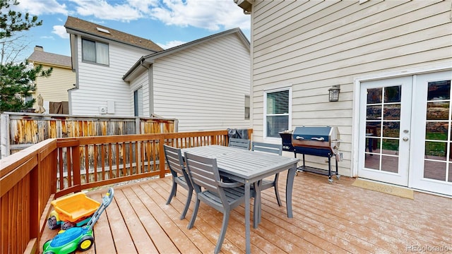 wooden terrace featuring french doors and area for grilling