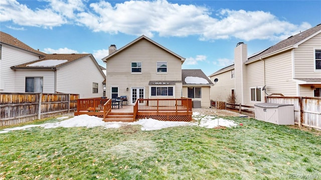 rear view of property with central air condition unit, a deck, and a lawn