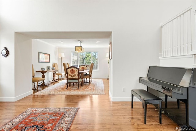 living area with light wood-style floors and baseboards