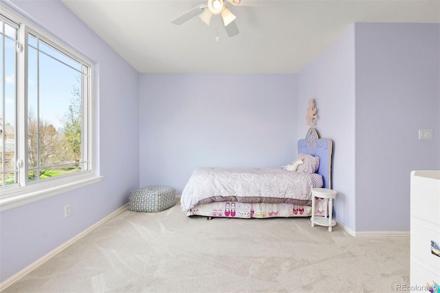 bedroom with carpet floors, baseboards, and multiple windows