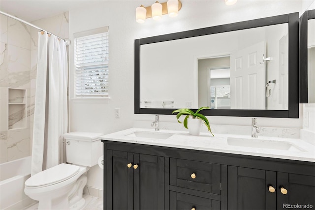 bathroom featuring a sink, shower / bath combo, toilet, and double vanity