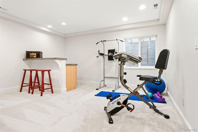 exercise area featuring baseboards, light colored carpet, recessed lighting, and visible vents