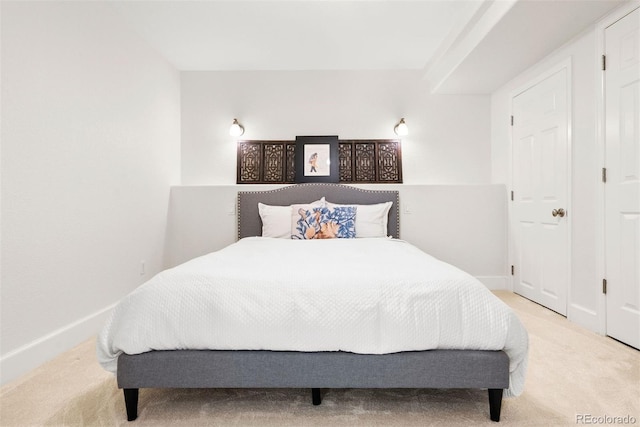 carpeted bedroom featuring baseboards