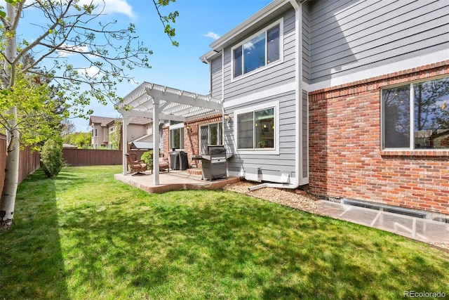 back of property featuring a pergola, brick siding, a fenced backyard, a patio area, and a yard