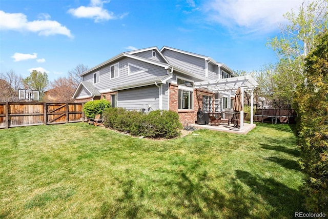 back of house with a pergola, brick siding, a fenced backyard, a patio area, and a lawn