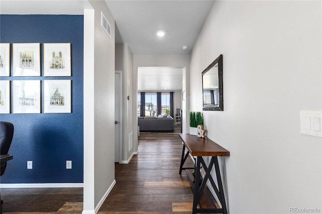 hallway with dark hardwood / wood-style flooring