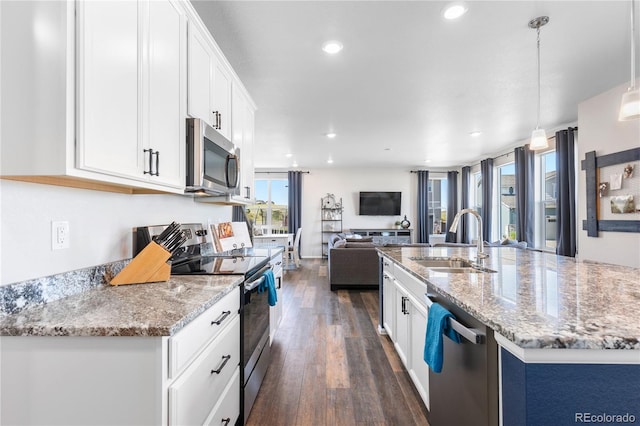 kitchen featuring sink, dark wood-type flooring, hanging light fixtures, stainless steel appliances, and white cabinets