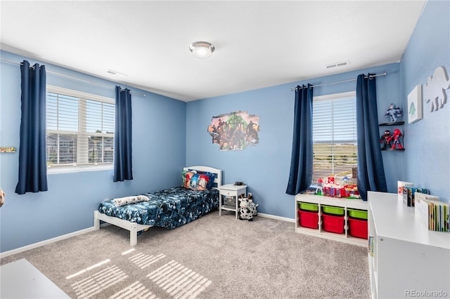 bedroom with multiple windows and carpet floors