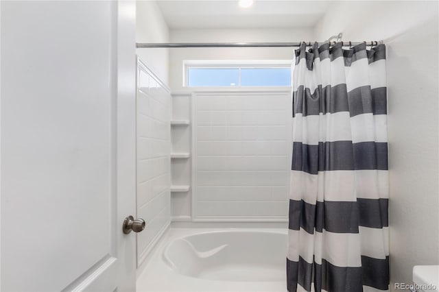 bathroom with shower / bathtub combination with curtain