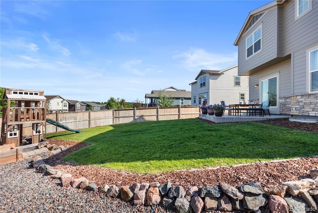 view of yard with a patio and a playground