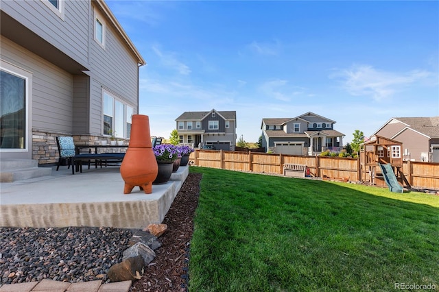 view of yard featuring a playground and a patio area