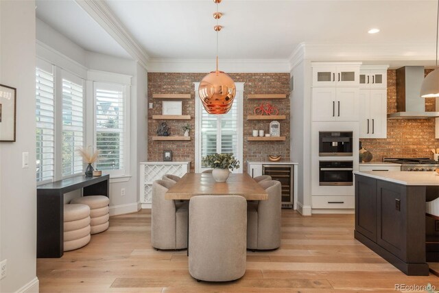 10252 E 58th Ave, Denver, CO 80238 - dining area featuring wine cooler, light wood-style flooring, crown molding, recessed lighting, and brick wall
