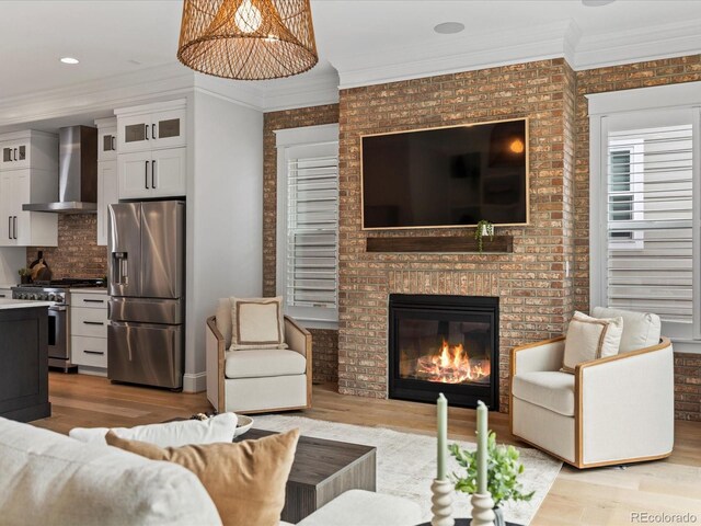 10252 E 58th Ave, Denver, CO 80238 - living room featuring light wood-type flooring, a fireplace, and crown molding