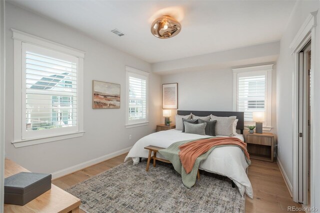 10252 E 58th Ave, Denver, CO 80238 - bedroom featuring light wood-style flooring and baseboards