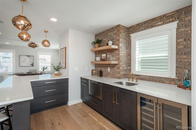 10252 E 58th Ave, Denver, CO 80238 - kitchen featuring wine cooler, dishwasher, light wood finished floors, a peninsula, and light countertops