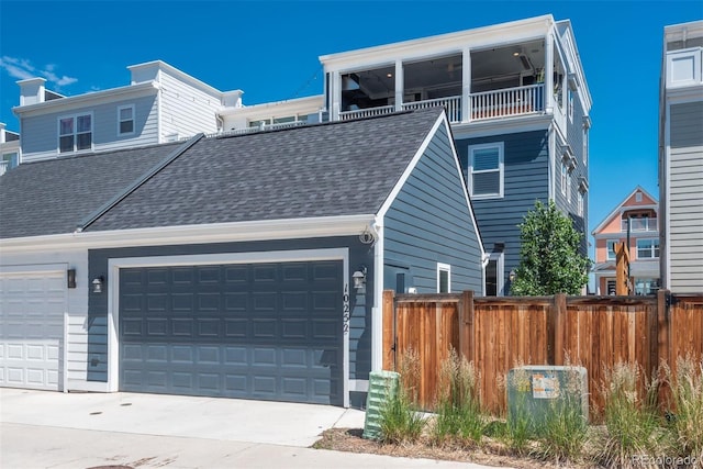 10252 E 58th Ave, Denver, CO 80238 - view of front of home with roof with shingles, a garage, and concrete driveway