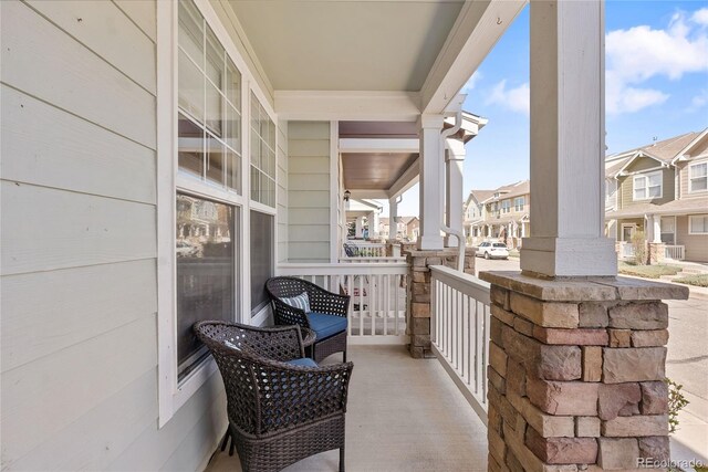 15612 E 96th Way Unit 21D, Commerce City, CO 80022 - balcony featuring covered porch and a residential view