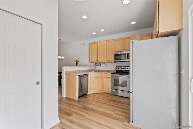 15612 E 96th Way Unit 21D, Commerce City, CO 80022 - kitchen with stainless steel appliances, recessed lighting, light wood-style flooring, light countertops, and light brown cabinetry