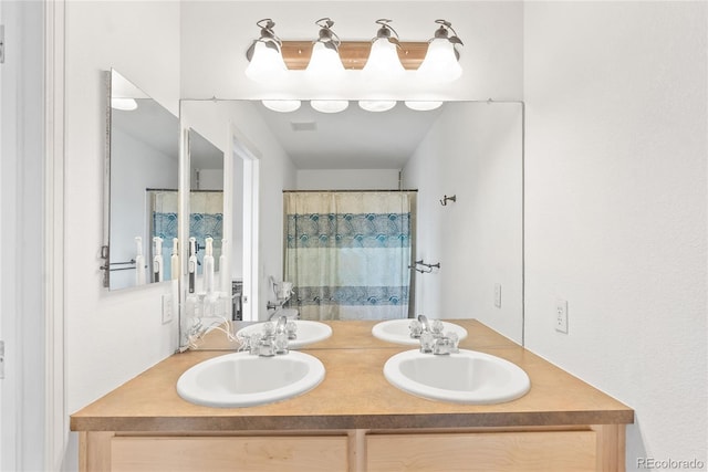 15612 E 96th Way Unit 21D, Commerce City, CO 80022 - full bathroom featuring double vanity, visible vents, a shower with curtain, and a sink