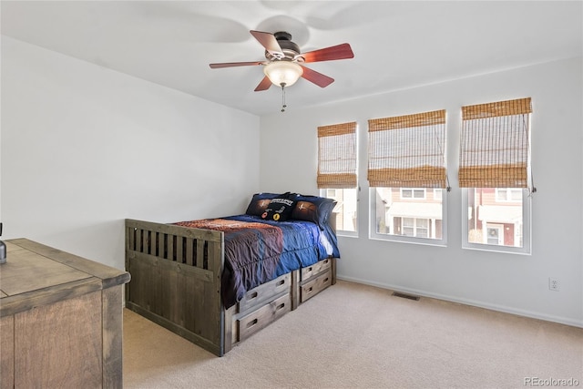 15612 E 96th Way Unit 21D, Commerce City, CO 80022 - bedroom featuring ceiling fan, light carpet, baseboards, and visible vents