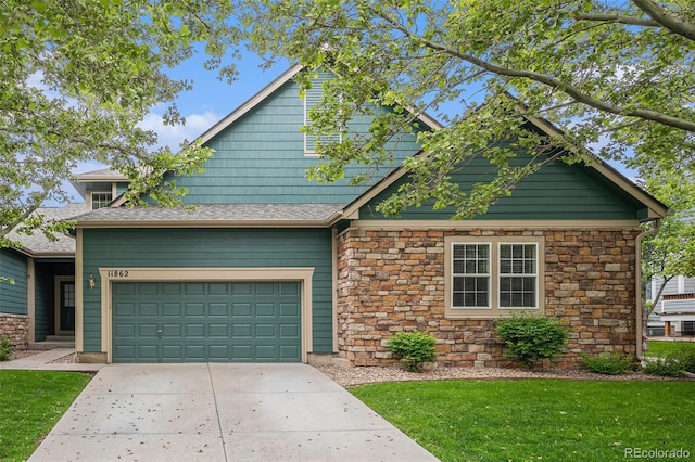11862 W Stanford Pl, Morrison, CO 80465 - craftsman house featuring stone siding, concrete driveway, and a front yard