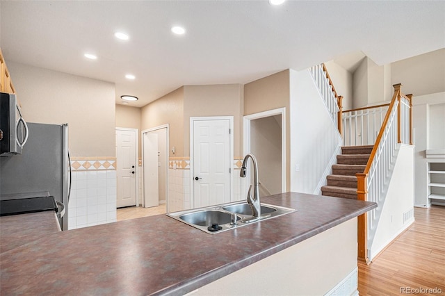 11862 W Stanford Pl, Morrison, CO 80465 - kitchen with a sink, stainless steel appliances, dark countertops, recessed lighting, and a peninsula
