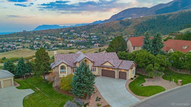 aerial view at dusk featuring a mountain view