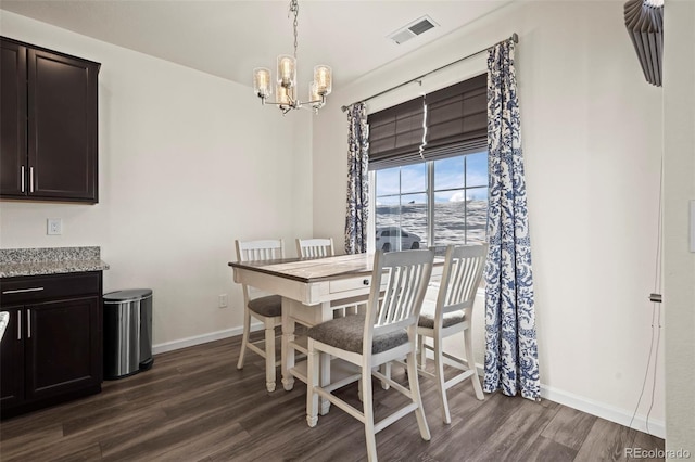 dining area featuring a notable chandelier and dark hardwood / wood-style floors