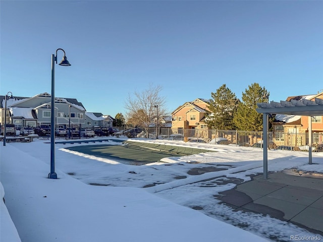 snowy yard with a covered pool