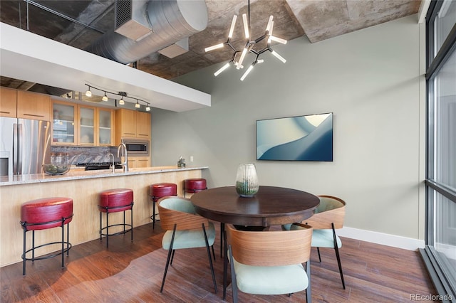 2100 16th St Unit 600, Denver, CO 80202 - dining area featuring a baseboard radiator, track lighting, dark wood-style floors, and baseboards