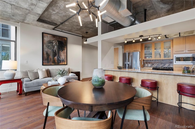 2100 16th St Unit 600, Denver, CO 80202 - dining space featuring track lighting, dark wood finished floors, and baseboards