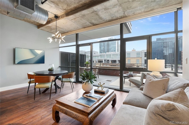 2100 16th St Unit 600, Denver, CO 80202 - living area featuring wood finished floors, a chandelier, a wall of windows, and baseboards