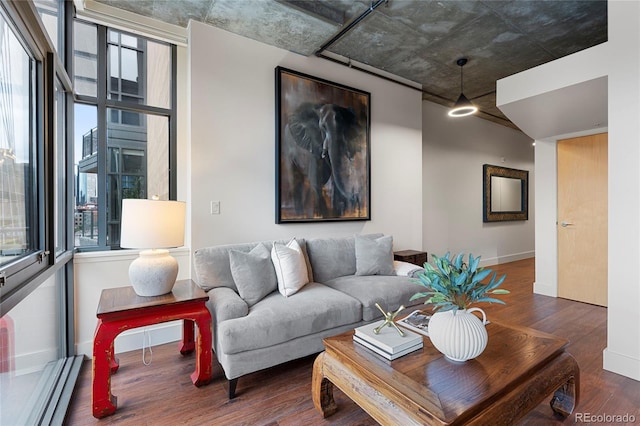 2100 16th St Unit 600, Denver, CO 80202 - living room featuring a baseboard radiator, wood finished floors, and baseboards