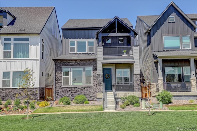 16550 Umatilla Pl, Broomfield, CO 80023 - craftsman inspired home featuring stone siding, board and batten siding, a balcony, and a front yard