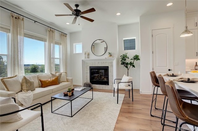 16550 Umatilla Pl, Broomfield, CO 80023 - living area featuring ceiling fan, recessed lighting, light wood finished floors, a fireplace, and baseboards