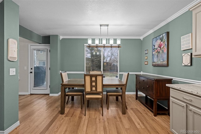 dining space with ornamental molding, light wood finished floors, and a wealth of natural light