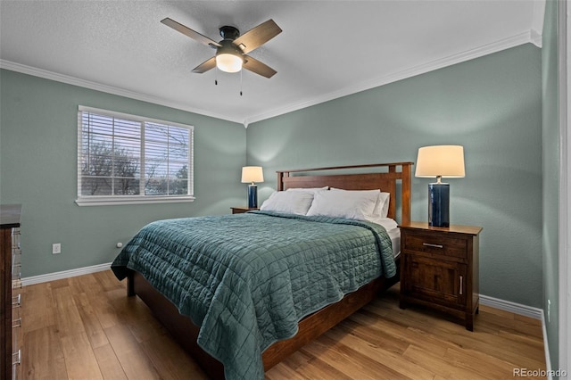 bedroom featuring light wood-type flooring, crown molding, baseboards, and ceiling fan