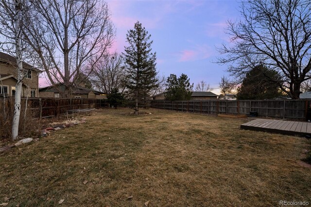 view of yard with a fenced backyard and a wooden deck