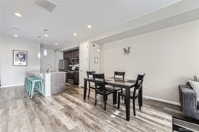 623 S Pitkin Ct, Aurora, CO 80017 - dining area featuring visible vents, light wood-style flooring, baseboards, and recessed lighting