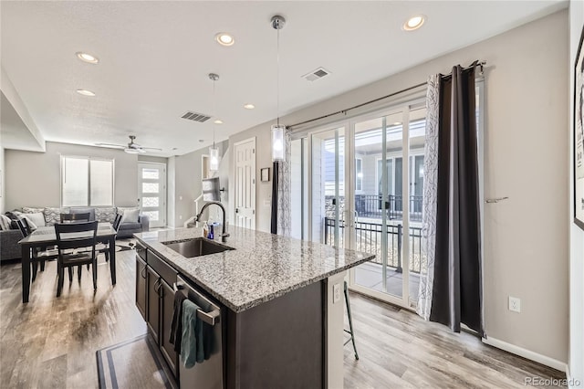 623 S Pitkin Ct, Aurora, CO 80017 - kitchen with stainless steel dishwasher, open floor plan, visible vents, and a sink