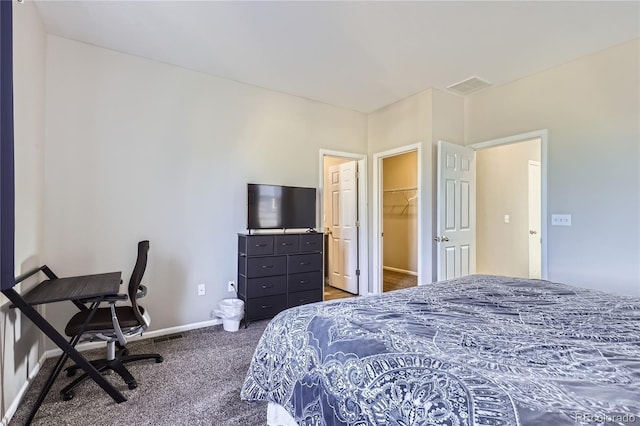 623 S Pitkin Ct, Aurora, CO 80017 - carpeted bedroom featuring visible vents, baseboards, and a walk in closet