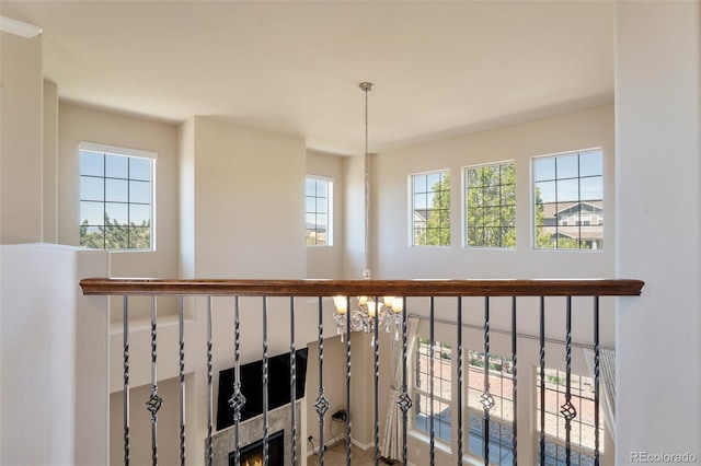 interior space with a fireplace, plenty of natural light, and a notable chandelier