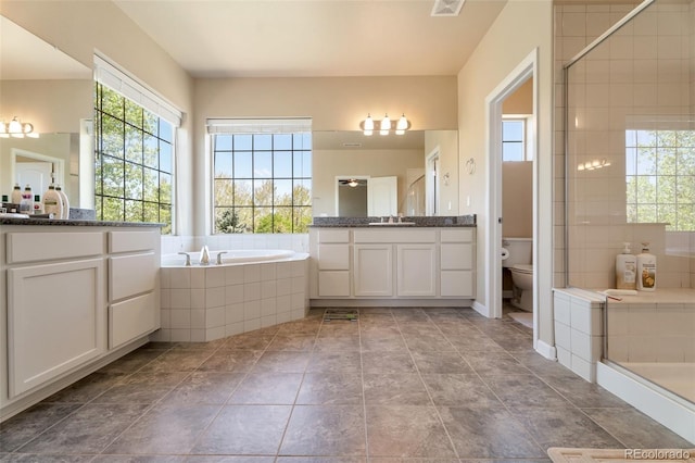 full bathroom with separate shower and tub, vanity, and toilet