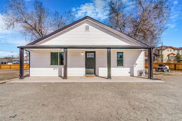 view of front of house featuring a patio area and fence