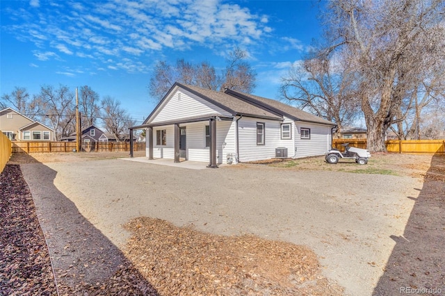 bungalow with a patio, a fenced backyard, and central AC